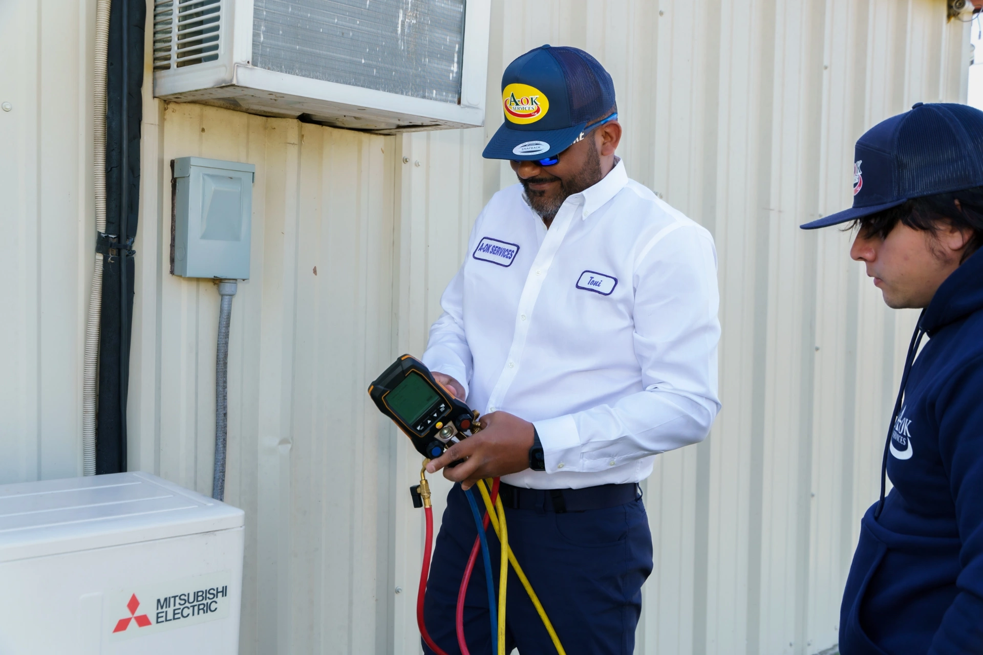 A-OK Services Technicians Installing Mitsubishi Electric AC System