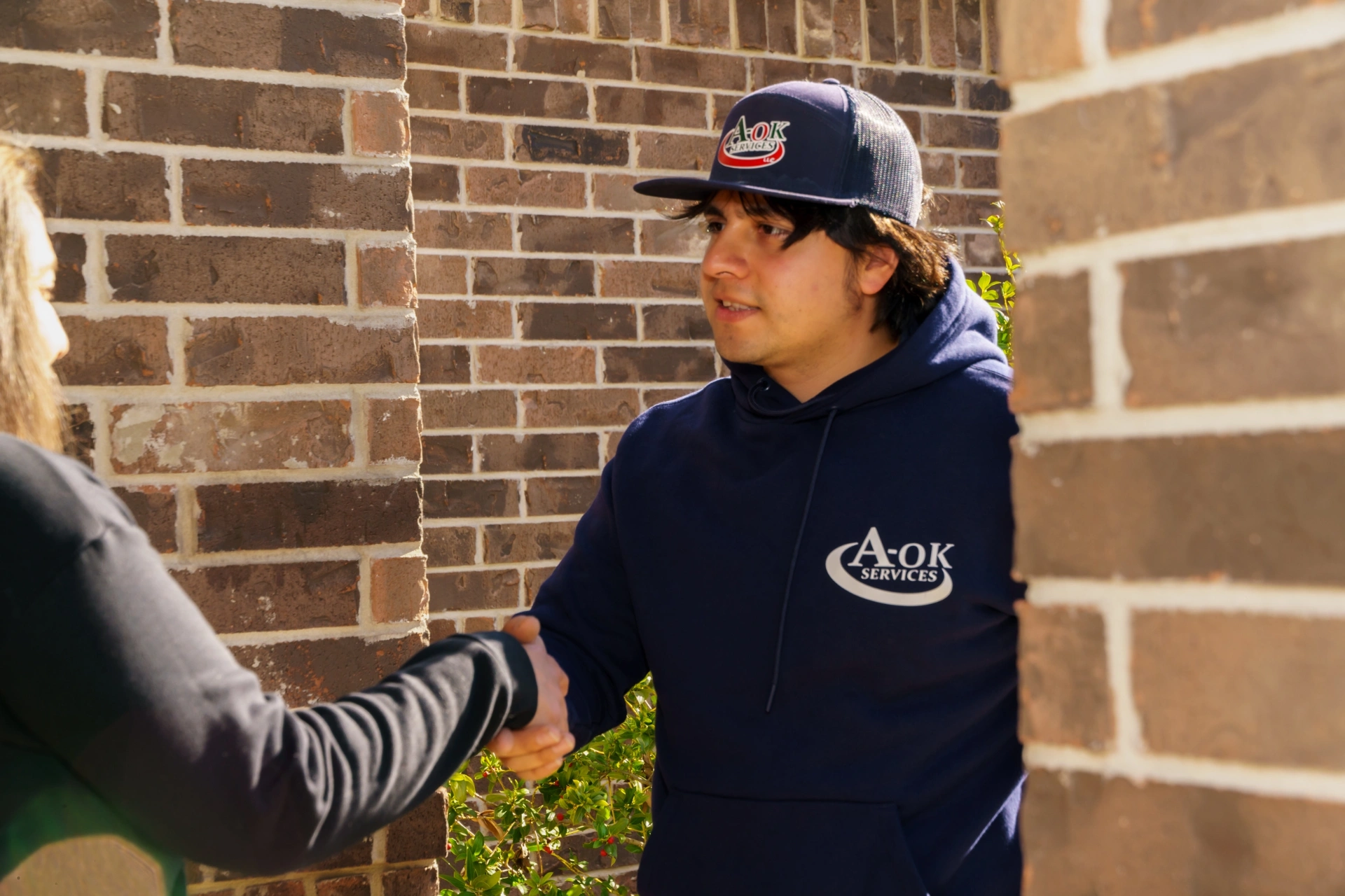 A-OK Services technician greeting Elmendorf customer