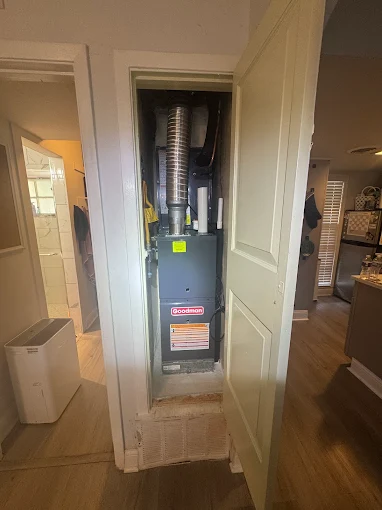 Professional furnace installation in residential closet space